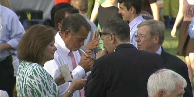 In this video frame from the White House congressional picnic on Wednesday, House Speaker John Boehner lights up.