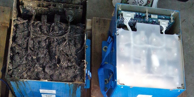 Jan. 17, 2013: This photo provided by the Japan Transport Safety Board shows the distorted main lithium-ion battery and its lid, left, of the All Nippon Airways' Boeing 787 which made an emergency landing on Wednesday, Jan. 16, 2013 at Takamatsu airport in Takamatsu, western Japan.
