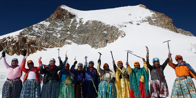 In this Dec. 16, 2015 photo, Aymara indigenous women pose for a picture as they reach the peak of the Huayna Potosi mountain on the outskirts of El Alto, Bolivia. From left are Cecilia Llusco, Juana Rufina Llusco Alana, Janet Mamani Callisaya, Domitila Alana Llusco, Marga Alana Llusco, Virginia Quispe Colque, Pacesa Llusco Alana, Lidia Huayllas, Bertha Vetia, Dora Magueno and Ana Gonzales. (AP Photo/Juan Karita)