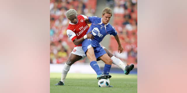 FILE- In this Sept. 11, 2010, file photo, Arsenal's Alexandre Song, left, vies for the ball with Bolton Wanderers' Stuart Holden during an English Premier League soccer match at Arsenal's Emirates Stadium in London. Holden is set to play his first match since being sidelined by another major knee injury last year. Bolton manager Dougie Freedman says Holden will play Monday, March 3, 2014 for the English team's under-21s against Everton. (AP Photo/Kirsty Wigglesworth, File)