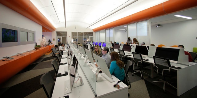 Patrons use computers at BiblioTech, a first of its kind digital public library, Wednesday, Dec. 11, 2013, in San Antonio. Bexar Countyâs BibiloTech is the nationâs only bookless public library, according to information gathered by the American Library Association, a distinction that has attracted scores of digital bookworms, plus emissaries from as far away as Hong Kong who want to learn about the idea and possibly take it home. (AP Photo/Eric Gay)