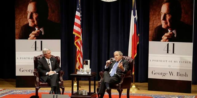 In this Tuesday, Nov. 11, 2014 photo, former President George W. Bush discusses his new book "41: A Portrait of My Father" with Andrew Card, his former chief of staff at his father's George H.W. Bush Presidential Library in College Station, Texas.