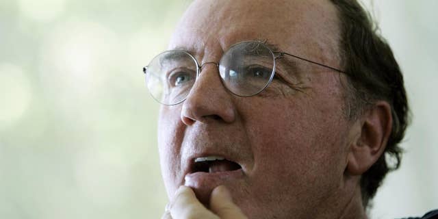 FILE - In this May 3, 2006, file photo, author James Patterson contemplates a question during an interview at his home overlooking the Intracoastal Waterway in Palm Beach, Fla. Patterson, who has donated millions to bookstores and libraries nationwide and formed his own publishing imprint, is visiting Baltimore on Wednesday, Sept. 16, 2015, and will donate 25,000 copies of his illustrated children’s book “Public School Superhero.” (AP Photo/Wilfredo Lee, File)
