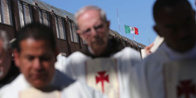 NOGALES, AZ - APRIL 01: Catholic clergy pray during a special 'Mass on the Border' on April 1, 2014 in Nogales, Arizona. Catholic bishops led by the Archbishop of Boston Cardinal Sean O'Malley held the mass at the U.S.-Mexico border fence to pray for comprehensive immigration reform and for those who have died along the border. (Photo by John Moore/Getty Images)