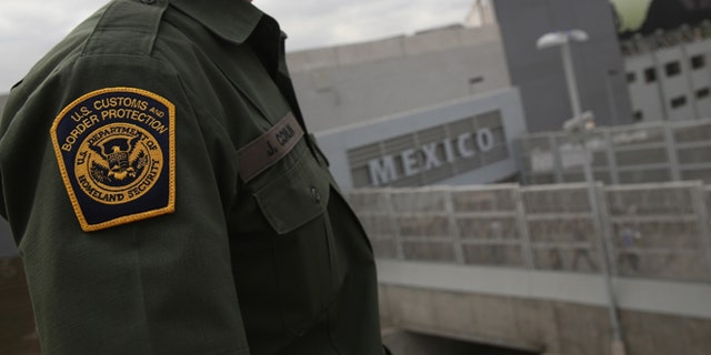 SAN YSIDRO, CA - OCTOBER 03: U.S. Border Patrol agent Jerry Conlin stands on the American side of the U.S.-Mexico border on October 3, 2013 at the San Ysidro port of enty into Mexico, California. While hundreds of thousands of government workers were furloughed due to the federal shutdown, thousands of Border Patrol agents, air-traffic controllers, prison guards and other federal employees deemed "essential" remain on duty, although their pay may be delayed. (Photo by John Moore/Getty Images)
