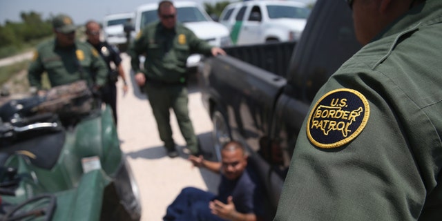 MISSION, TX - JULY 24: U.S. Border Patrol agents detain a suspected smuggler after he allegedly transported undocumented immigrants who crossed the Rio Grande from Mexico into the United States on July 24, 2014 in Mission, Texas. Tens of thousands of undocumented immigrants, many of them unaccompanied minors, have crossed illegally into the United States this year and presented themselves to federal agents, causing a humanitarian crisis on the U.S.-Mexico border. (Photo by John Moore/Getty Images)