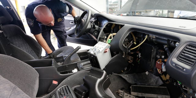 June 27, 2013: Customs and Border Protection officer Steve Delgado looks in at the dismembered dashboard of a Honda Accord after finding more than 14 pounds of methamphetamine hidden behind the radio at the San Ysidro port of entry in San Diego.