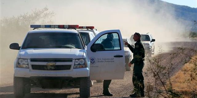 FILE - In this Oct. 2, 1012 file photo, several U.S. Customs and Border Protection officers and other law enforcement jurisdictions drive the roads near where a U.S. Border Patrol agent was shot and killed, and one other was shot and injured, where the shooting took place, near Bisbee, Ariz. Border Patrol agents in southern Arizona are subjecting U.S. citizens to illegal searches, detentions and excessive force in many cases miles from the state's border with Mexico, the American Civil Liberties Union wrote in a complaint Wednesday, Oct. 9, 2013. (AP Photo/Ross D. Franklin, file)