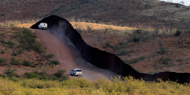 U.S. Border Patrol agents patrol the border fence near where a U.S. Border Patrol agent Nicholas Ivie was shot and killed, and one other was shot and injured, in Naco, Arizona