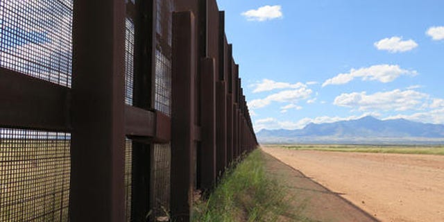 This Wednesday, Sept. 16, 2015 photo shows a part of the border fence near Naco, Ariz., during a tour of the border hosted by the Cochise County Sheriff's Office. Ranchers in this area say the border needs a wall to keep out drug smugglers and illegal border crossers. (AP Photo/Astrid Galvan)