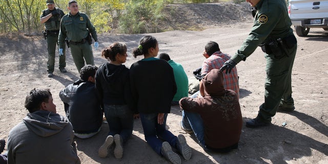 MISSION, TX - APRIL 11: U.S. Border Patrol agents detain undocumented immigrants near the U.S.-Mexico border on April 11, 2013 near Mission, Texas. A group of 16 immigrants from Mexico and El Salvador said they crossed the Rio Grande River from Mexico into Texas during the morning hours before they were caught. The Rio Grande Valley sector of has seen more than a 50 percent increase in illegal immigrant crossings from last year, according to the Border Patrol. Agents say they have also seen an additional surge in immigrant traffic since immigration reform negotiations began this year in Washington D.C. Proposed refoms could provide a path to citizenship for many of the estimated 11 million undocumented workers living in the United States. Photo by John Moore/Getty Images) (Photo by John Moore/Getty Images)
