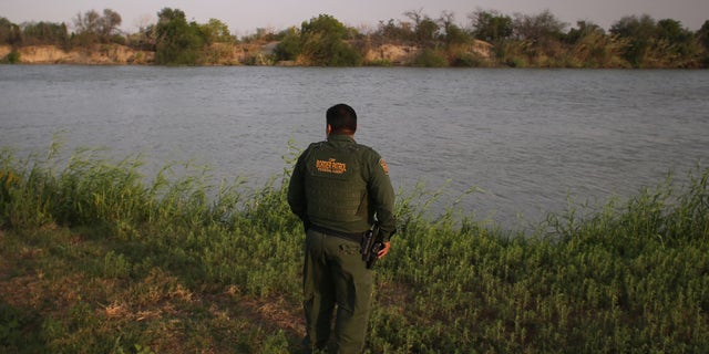 MCALLEN, TX - APRIL 10: U.S. Border Patrol agent Sal De Leon looks across the Rio Grande River into Mexico at the U.S.-Mexico border while on patrol on April 10, 2013 in McAllen, Texas. (Photo by John Moore/Getty Images)