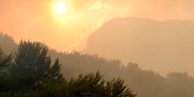 View from the Bosnian military helicopter of the sunset on the hills hit by a wildfires near the village Glogosnica, 70kms south of Sarajevo, Bosnia on Thursday Aug. 30. 2012. Bosnian military helicopter helps fighting the raging wildfires in the southern Bosnian region as the area has been hit by record high temperatures and no rain. (AP Photo/Sulejman Omerbasic)