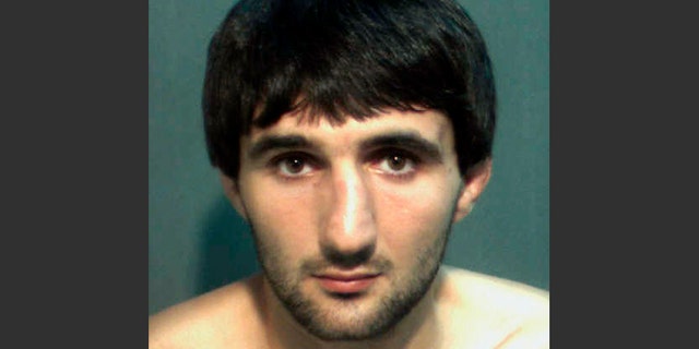 FILE- This May 4, 2013 file photo provided by the Orange County Corrections Department in Orlando, Fla., shows Ibragim Todashev after his arrest for aggravated battery in Orlando. A report released Tuesday, March 25, 2014, determined that an FBI agent was justified in fatally shooting Todashev, who became violent after he had agreed to give a statement about his involvement in a triple slaying in Massachusetts last May. (AP Photo/Orange County Corrections Department)