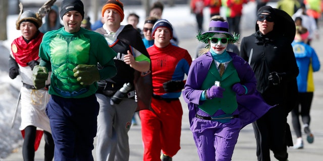 Runners in costume train for the Boston Marathon in Newton, Mass., Saturday, March 1, 2014. People running this year's Boston Marathon for charity gathered for a 17-mile training run along the last 17 miles of the course. (AP Photo/Michael Dwyer)