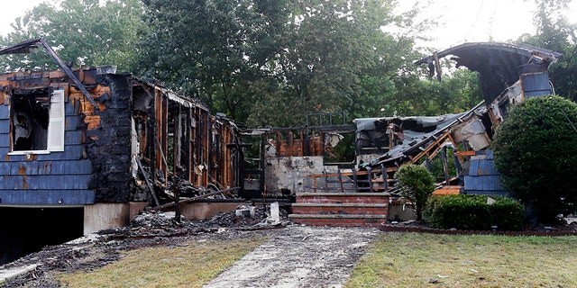 The house owned by Lawrence Police Officer Ivan Soto sits nearly burned to the ground on Jefferson Street, in Lawrence, Mass., Friday, Sept. 14, 2018.