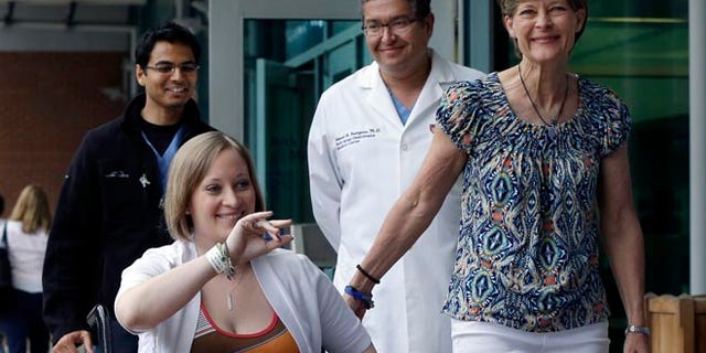 June 3: Erika Brannock, 29, a Baltimore area pre-school teacher who lost a leg in the Boston Marathon bombings, is accompanied by her mother, Carol Downing, right, as she is released from Beth Israel Deaconess Medical Center.