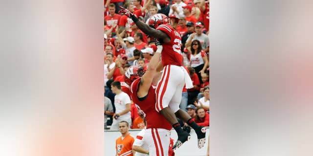 Wisconsin's Melvin Gordon is lifted by teammate Rob Havenstein after Gordon's 69-yard touchdown run during the second half of an NCAA college football game against Bowling Green, Saturday, Sept. 20, 2014, in Madison, Wis. (AP Photo/Morry Gash)