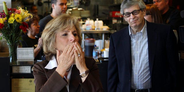 Sen. Barbara Boxer, accompanied by her husband Stewart, right, stops into the Oakland Grill, a favorite eatery, to thank supporters on this Election Day