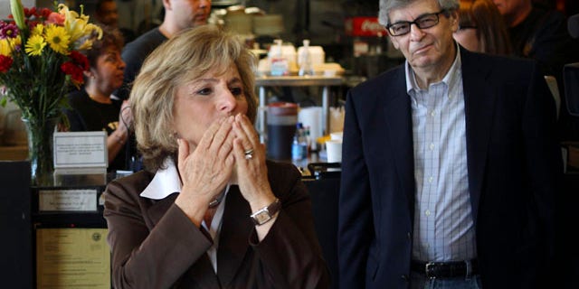 Sen. Barbara Boxer, accompanied by her husband Stewart, right, stops into the Oakland Grill, a favorite eatery, to thank supporters on this Election Day
