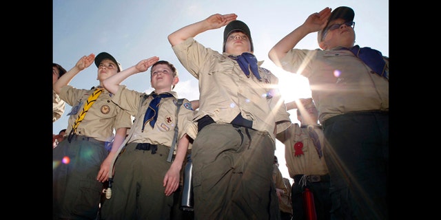 Boy Scouts salute early Saturday morning, May 21, 2011 during New Jersey's Boy Scouts Camporee in Sea Girt, N.J. The Boy Scouts of America's National Council has voted to ease a long-standing ban and allow openly gay boys to be accepted as Scouts, Thursday, May 23, 2013.