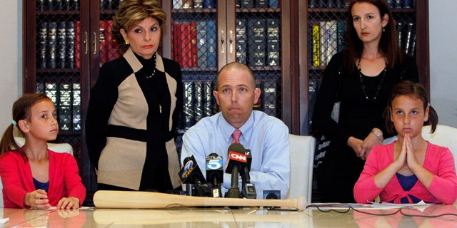 April 27: Justin Quinn, center, with his wife Jessica, right, and their twin daughters: Kylynn, far left, and Taylor, far right, take questions during a news conference organized by Los Angeles attorney Gloria Allred, standing left, in Los Angeles.