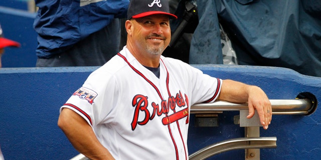 Atlanta Braves manager Fredi Gonzalez (33) smiles in the dugout prior to a baseball game against the Philadelphia Phillies, Thursday, May 12, 2016, in Atlanta. (AP Photo/Brett Davis)