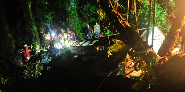 Rescue personnel work at the site where a tourist bus crashed killing at least 49 people, according to the the Santa Catarina State security secretary, near the city of Joinville, southern state of Santa Catarina, Brazil, Saturday, March 14, 2015. (AP Photo/Salmo Duarte, Agence RBS)