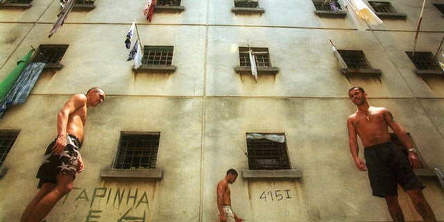 Inmates walk around a yard at the Carandiru detention center in Sao Paulo, Brazil, Oct. 11, 2000. Built for 3,200 inmates, the prison, which is perhaps best known for the massacre of 111 inmates by riot police during a 1992 rebellion, now houses 7,300 inmates and still smolders with violence and unrest. (AP Photo/Dario Lopez-Mills)