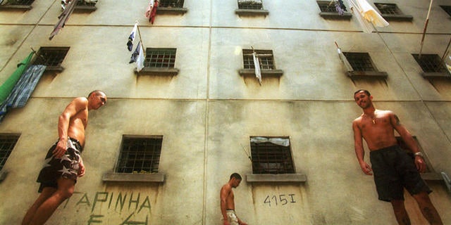 Inmates walk around a yard at the Carandiru detention center in Sao Paulo, Brazil, Oct. 11, 2000. Built for 3,200 inmates, the prison, which is perhaps best known for the massacre of 111 inmates by riot police during a 1992 rebellion, now houses 7,300 inmates and still smolders with violence and unrest. (AP Photo/Dario Lopez-Mills)