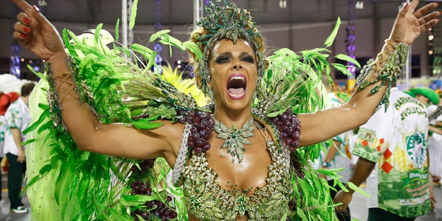 A dancer from the Mancha Verde samba school performs in the Carnival parade at the Sambodromo in Sao Paulo, Brazil, Friday, Feb. 13, 2015. (AP Photo/Andre Penner)