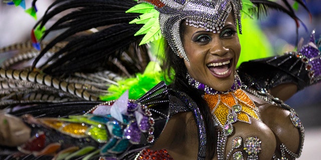 A performer from the Mocidade samba school parades during carnival celebrations at the Sambadrome in Rio de Janeiro, Brazil, Monday, March 3, 2014. Brazil's Carnival is maintaining its frenetic pace, with hundreds of roving parties taking over Rio de Janeiro's streets and famed samba school parades heading into their final night. (AP Photo/Felipe Dana)