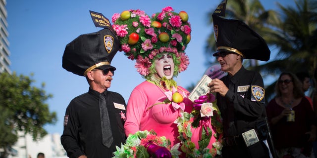Revelers strike a pose at the Banda de Ipanema carnival block party in Rio de Janeiro, Brazil, Saturday, Jan. 23, 2016. Rio de Janeiro's over-the-top Carnival is the highlight of the year for many local residents. Hundreds of thousands of merrymakers will take to Rio's streets in hundreds of open-air "bloco" parties. (AP Photo/Felipe Dana)
