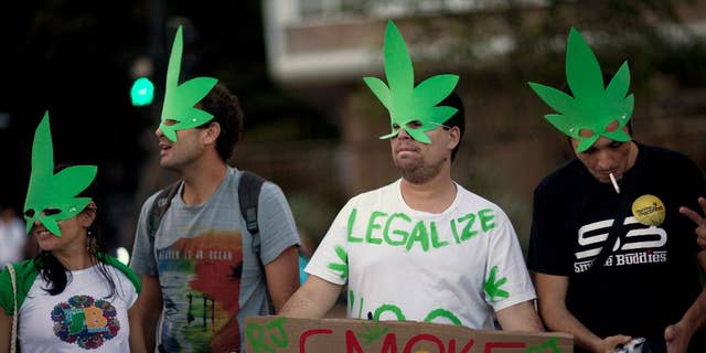 FILE - In this May 11, 2013 file photo, demonstrators wear cannabis shaped masks to support the legalization of marijuana in Rio de Janeiro, Brazil, during a march marking the 32 anniversary of Jamaican musician Bob Marley's death. Brazil's Supreme Court on Wednesday, Aug. 19, 2015 began debating a drug case that could lead to the decriminalization of drug possession for personal use. A final ruling is not expected for several days. (AP Photo/Felipe Dana, File)