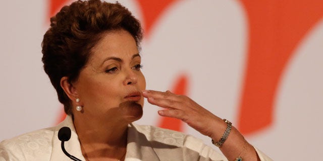 October 5, 2014: Brazil's President Dilma Rousseff blows a kiss during a press conference in Brasilia. Official results showed Sunday that President Dilma Rousseff will face challenger Aecio Neves in a second-round vote in Brazil's most unpredictable presidential election since the nation's return to democracy nearly three decades ago. (AP Photo/Eraldo Peres)