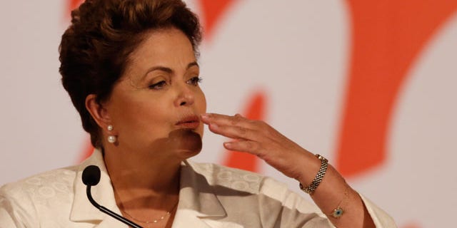 October 5, 2014: Brazil's President Dilma Rousseff blows a kiss during a press conference in Brasilia. Official results showed Sunday that President Dilma Rousseff will face challenger Aecio Neves in a second-round vote in Brazil's most unpredictable presidential election since the nation's return to democracy nearly three decades ago. (AP Photo/Eraldo Peres)