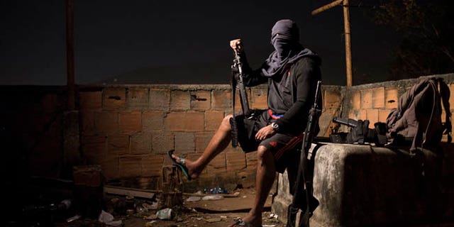 A drug gang leader poses for a photo in a slum in Rio de Janeiro, Brazil.