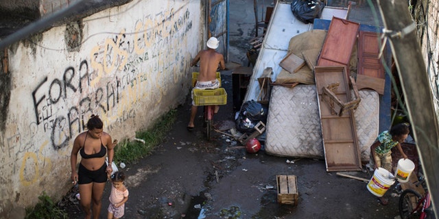 Residents walk inside the Favela do Metro slum near Maracana stadium, on Jan. 9, 2014.
