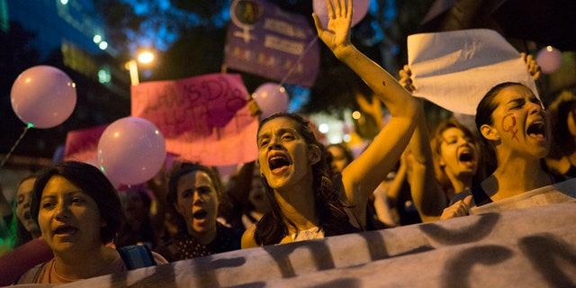 Women participate in a demonstration against gender violence in Rio de Janeiro, Brazil, Tuesday, Oct. 25, 2016. Women in Brazil organized protests condemning violence against women following the brutal gang rape of a woman on the outskirts of Rio de Janeiro by suspected drug dealers. (AP Photo/Leo Correa)
