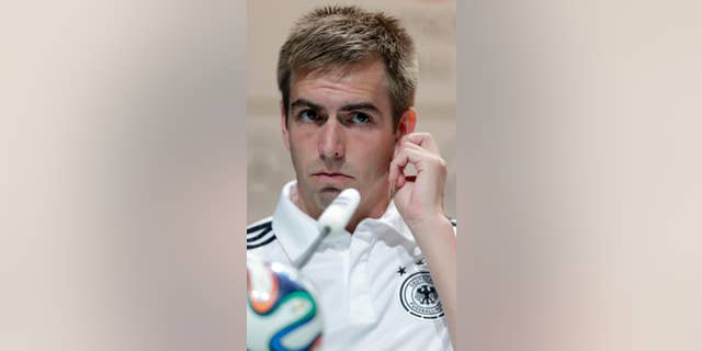 Germany's national soccer team captain Philipp Lahm listens to reporters' questions during a news conference in Porto Seguro, Brazil, Tuesday, June 10, 2014. Germany will play in group G of the Brazil 2014 soccer World Cup. (AP Photo/Matthias Schrader)