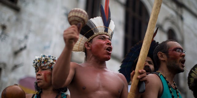 A group of indigenous people chants slogans on the grounds of an old Indian museum, in Rio de Janeiro, Brazil, Saturday, Jan. 12, 2013.