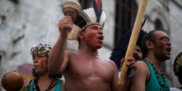 A group of indigenous people chants slogans on the grounds of an old Indian museum, in Rio de Janeiro, Brazil, Saturday, Jan. 12, 2013.