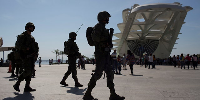 Soldiers patrol outside the Museum of Tomorrow in Rio de Janeiro, Brazil, Saturday, July 9, 2016. Roughly twice the security contingent at the London Olympics will be deployed during the August games in Rio, which are expected to draw thousands of foreigners to a city where armed muggings, stray bullets and turf wars between heavily armed drug gangs are routine. (AP Photo/Leo Correa)