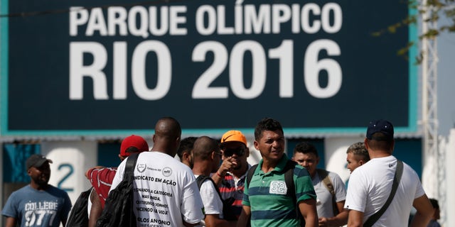 April 8, 2014: Striking workers stand in front the entrance of the Olympic Park, the main cluster of venues under construction for the 2016 Summer Olympic Games, in Rio de Janeiro, Brazil.