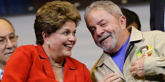 FILE - In this Aug. 7, 2014,file photo, Brazil's President Dilma Rousseff and former Brazilian President Luiz Ignacio Lula da Silva attend an election campaign rally in Sao Paulo, Brazil. A convicted black market money dealer who turned state’s evidence told lawmakers on Tuesday, Aug. 25, 2015, that President Rousseff and her predecessor, former President Lula da Silva, knew of the sprawling corruption kickback scheme that has engulfed state-run oil company Petrobras. (AP Photo/Andre Penner,File)