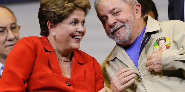 FILE - In this Aug. 7, 2014,file photo, Brazil's President Dilma Rousseff and former Brazilian President Luiz Ignacio Lula da Silva attend an election campaign rally in Sao Paulo, Brazil. A convicted black market money dealer who turned state’s evidence told lawmakers on Tuesday, Aug. 25, 2015, that President Rousseff and her predecessor, former President Lula da Silva, knew of the sprawling corruption kickback scheme that has engulfed state-run oil company Petrobras. (AP Photo/Andre Penner,File)