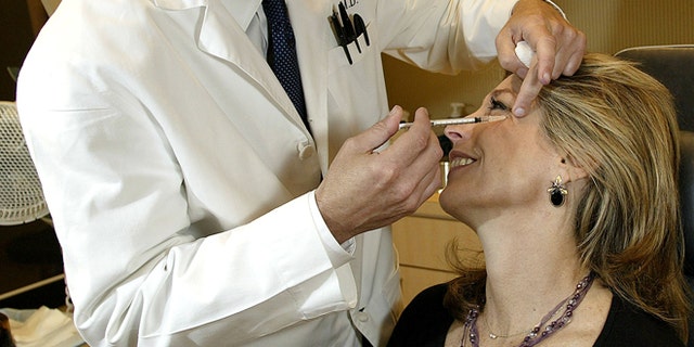 404141 01: Dr. Louis P. Bucky, M.D., F.A.C.S., injects Botox into the face of Betsy Rubenstone, 50, from the Philadelphia area, April 18, 2002 at the Plastic &amp; Reconstructive Surgery Center at the Pennsylvania Hospital in Philadelphia. When injected into facial muscles Botox or botulinum toxin eliminates wrinkles by weakening or paralyzing the muscles which keeps them from contracting. The effect lasted for up to three months. The U.S. Food and Drug Administration (FDA) approved cosmetic use of Botox April 15, 2002. (Photo by Don Murray/Getty Images)
