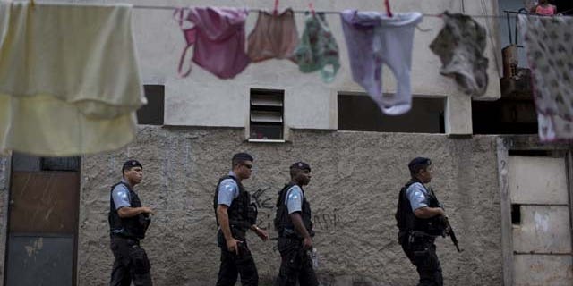 July 21, 2013: Policemen from the Pacifying Police Unit, or 'UPP', patrol in the Varginha area of the Manguinhos slum complex where Pope Francis will visit next week during his trip to Rio de Janeiro, Brazil (AP Photo)
