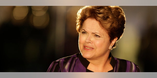 Brazil's President Dilma Rousseff arrives to meet members of Brazil's soccer team at Alvorada palace in Brasilia, Brazil, Monday, Sept. 2, 2013. The Brazilian government condemned a U.S. spy program that reportedly targeted the nation's leader, labeled it an "unacceptable invasion" of sovereignty and called Monday for international regulations to protect citizens and governments alike from cyber espionage. (AP Photo/Eraldo Peres)