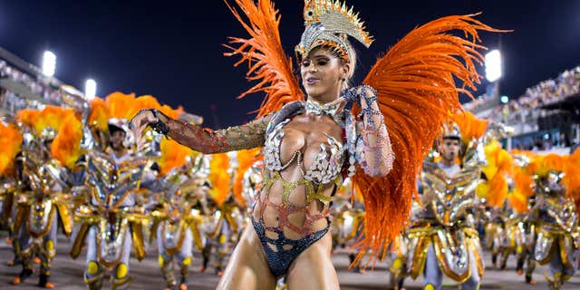 RIO DE JANEIRO, BRAZIL - MARCH 03: Members of Unidos da Tijuca Samba School during their parade at 2014 Brazilian Carnival at Sapucai Sambadrome on March 03, 2014 in Rio de Janeiro, Brazil. Rio's two nights of Carnival parades began on March 2 in a burst of fireworks and to the cheers of thousands of tourists and locals who have previously enjoyed street celebrations (known as "blocos de rua") all around the city. (Photo by Buda Mendes/Getty Images)